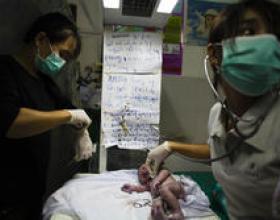 Doctor checking infant vitals